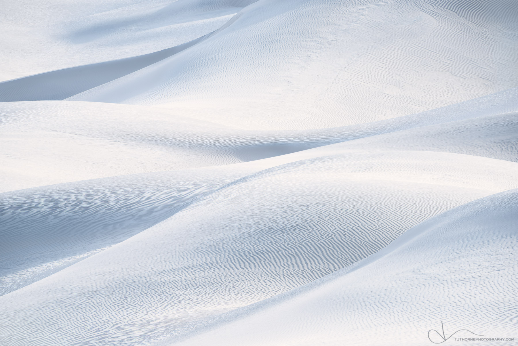 An intimate abstract view of soft light on sand dunes in Death Valley National Park, California.